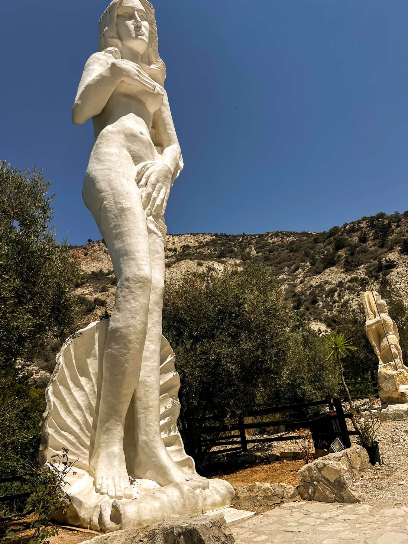 White figure of Aphrodite against a blue sky