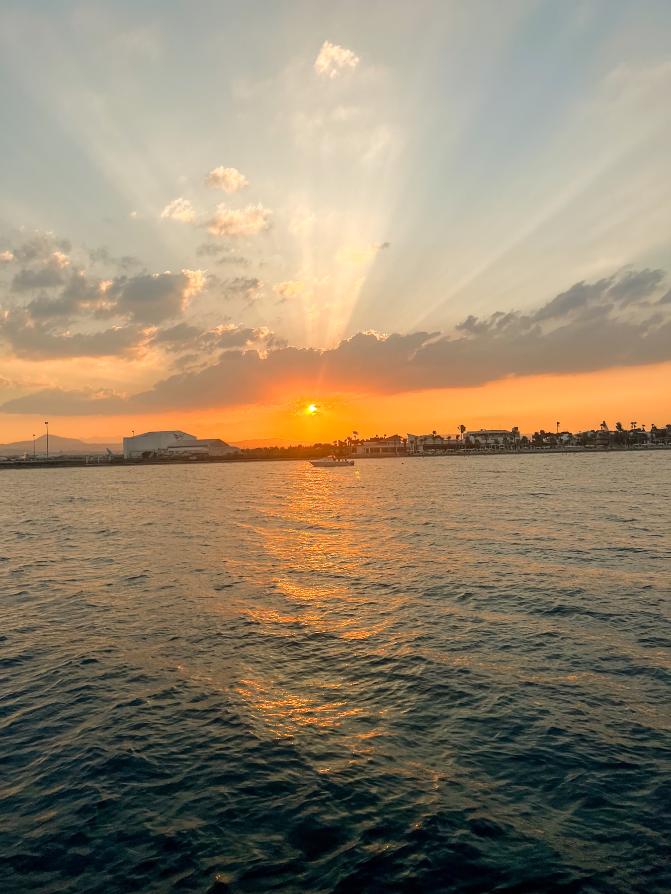 Orange sunset seen from a boat in Larnaca