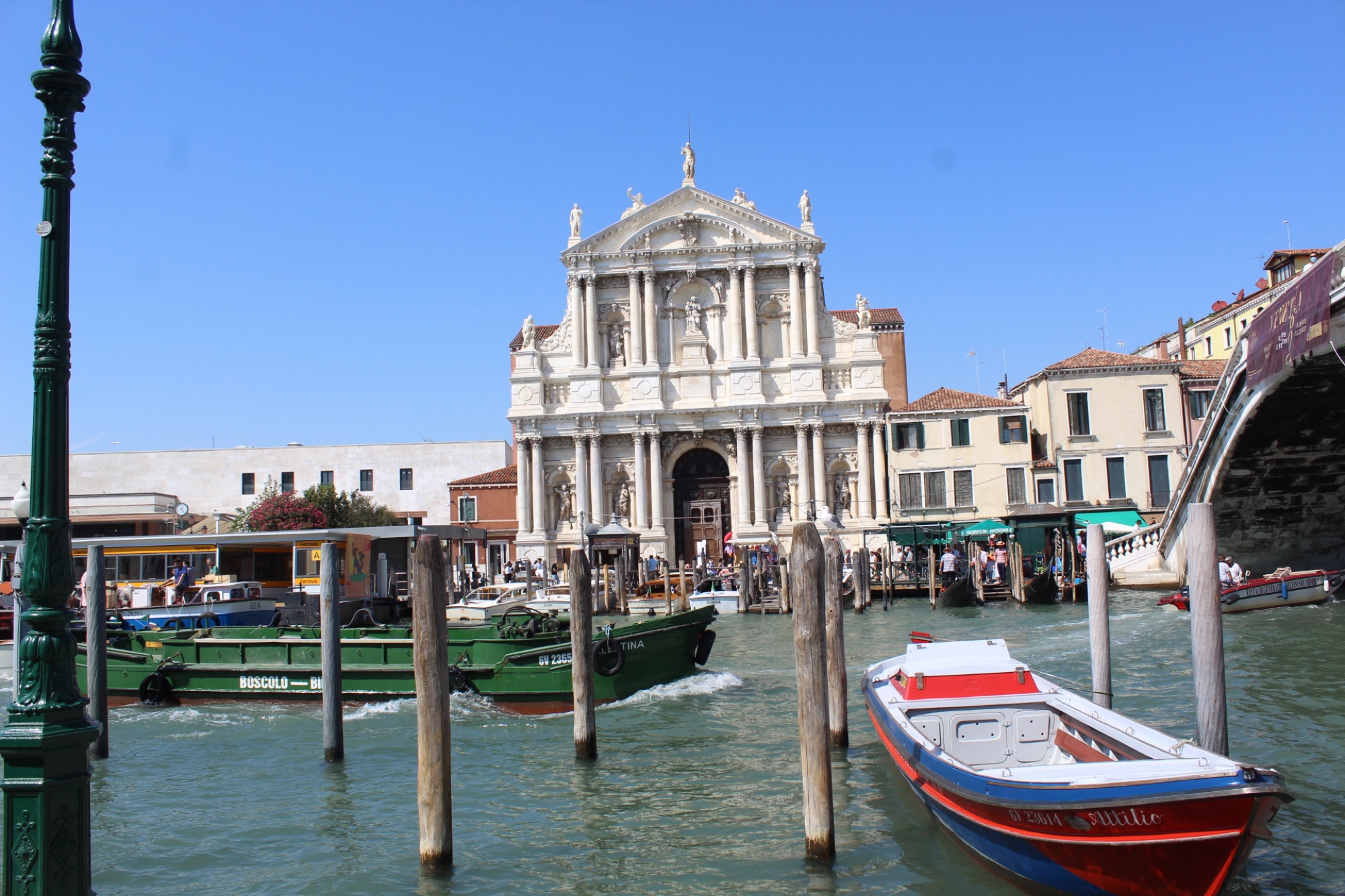 Church and boats beside a busy Venetian canal