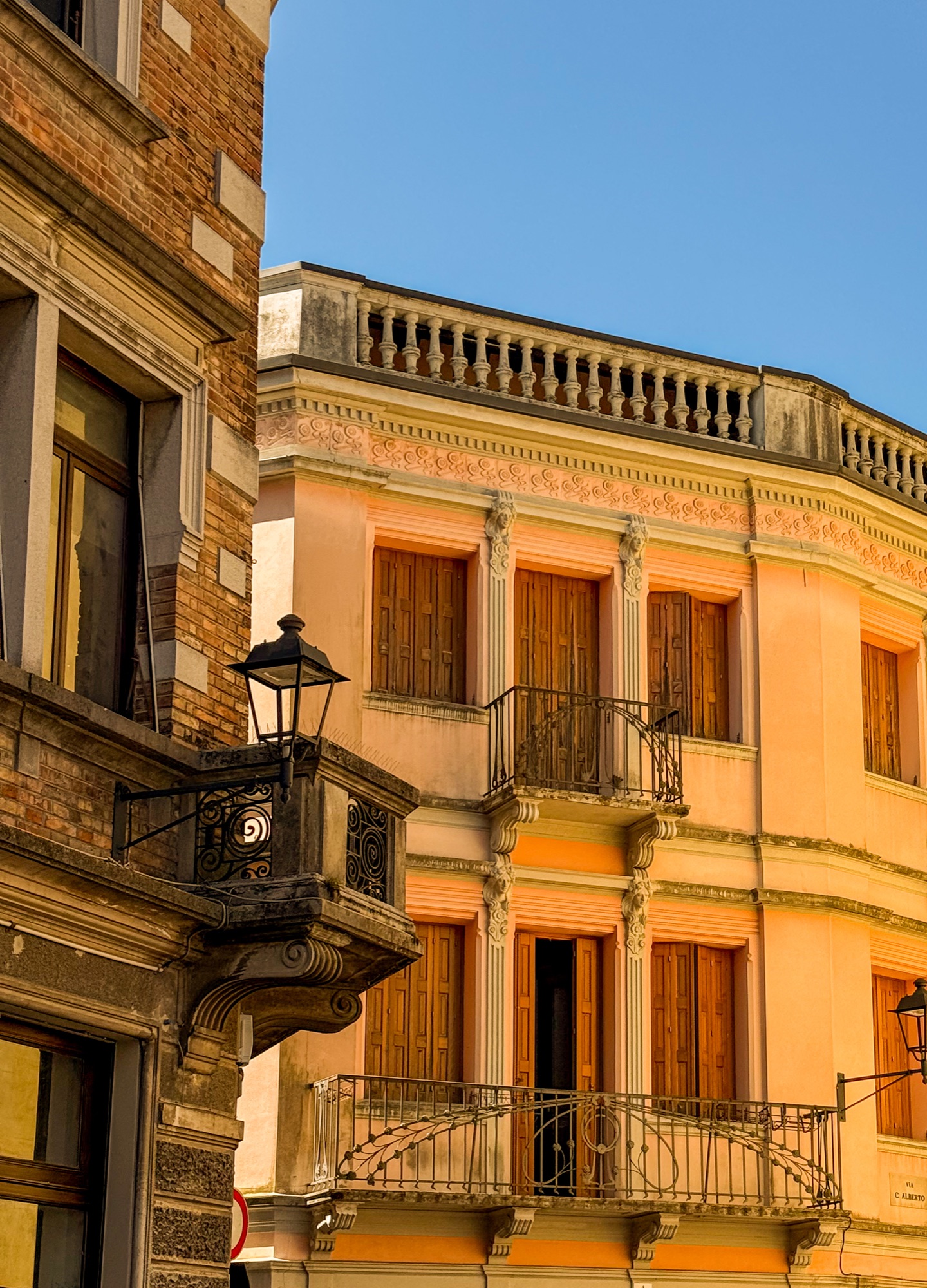 Warm ochre façades, shutters and balconies in northern Italy