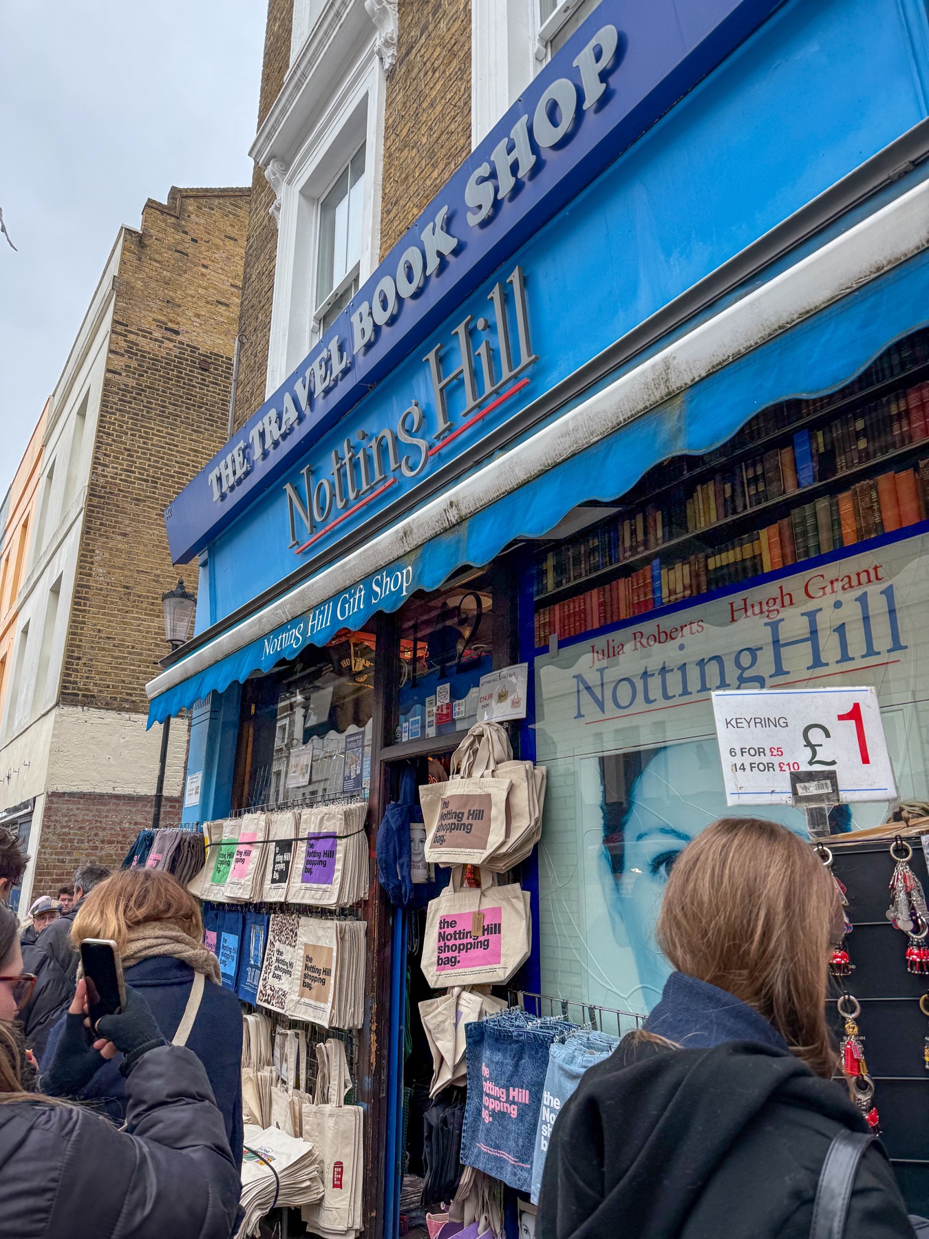 Blue Notting Hill travel book shop crowded with visitors