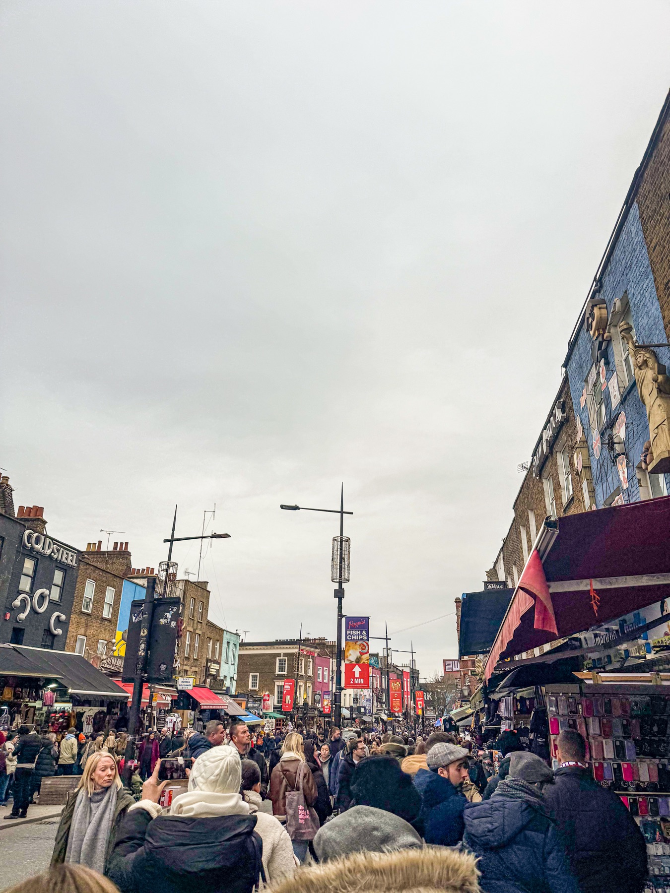A dense crowd moving through Camden Market